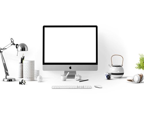 A modern and tidy home workspace with natural daylight coming from a side window